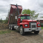 Image of a dump truck dumping dirt