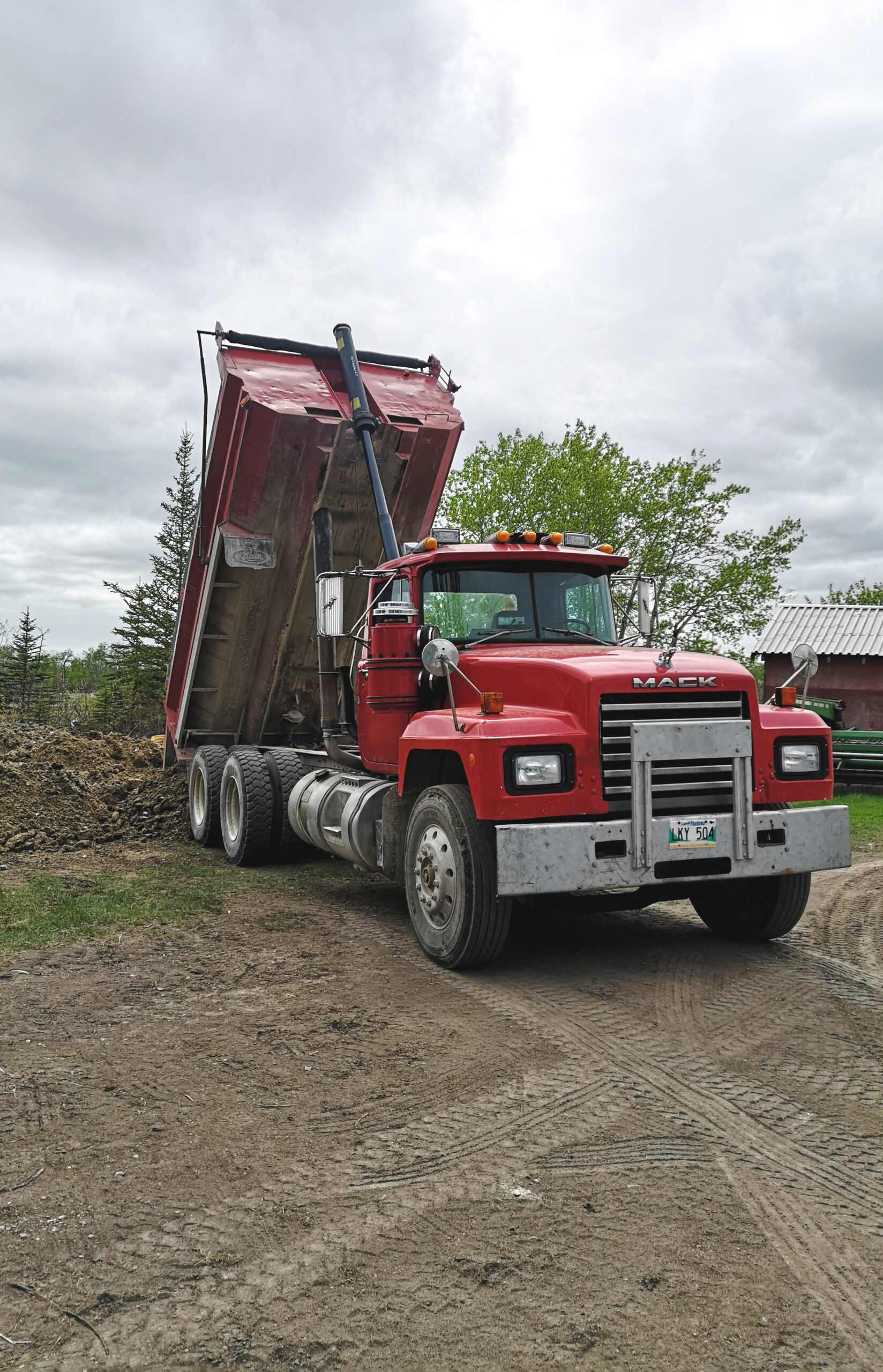 Image of a dump truck dumping dirt