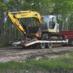image of an excavator on a trailer