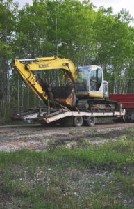 image of an excavator on a trailer