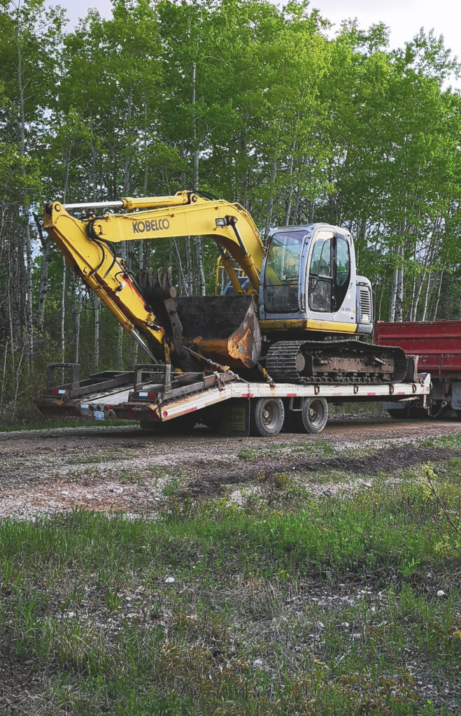 image of an excavator on a trailer