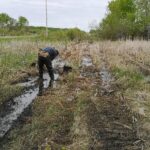man making a fence in rain
