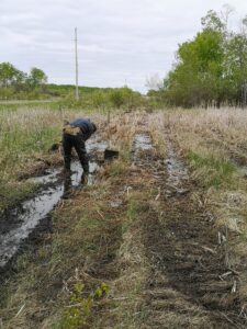 man making a fence in rain