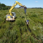 excavator making a fence