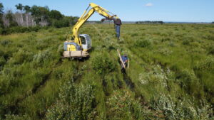 excavator making a fence